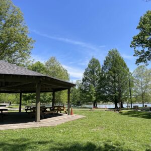 Riverview Shelter in Shelby Park in Nashville, Tennessee, with picnic tables, green space, and water visible nearby.