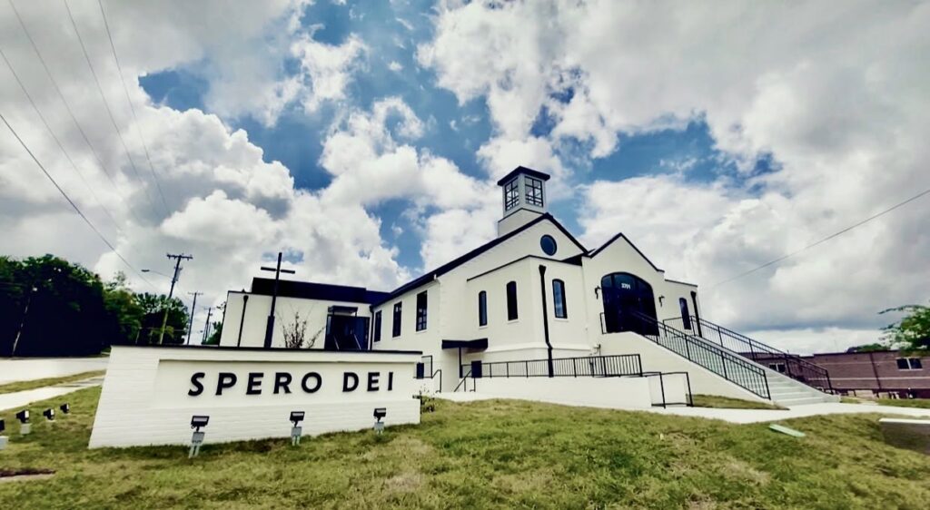 Exterior of Spero Dei church in Nashville, Tennessee, with white stucco walls, black trim, and Spero Dei signage.
