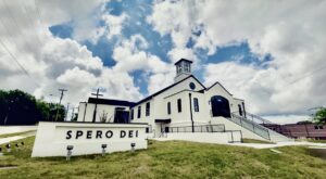 Exterior of Spero Dei church in Nashville, Tennessee, with white stucco walls, black trim, and Spero Dei signage.