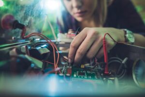 Student working with electronic equipment, representing technical and workforce training at TCAT Murfreesboro’s Smyrna Campus and Nissan Training Center.
