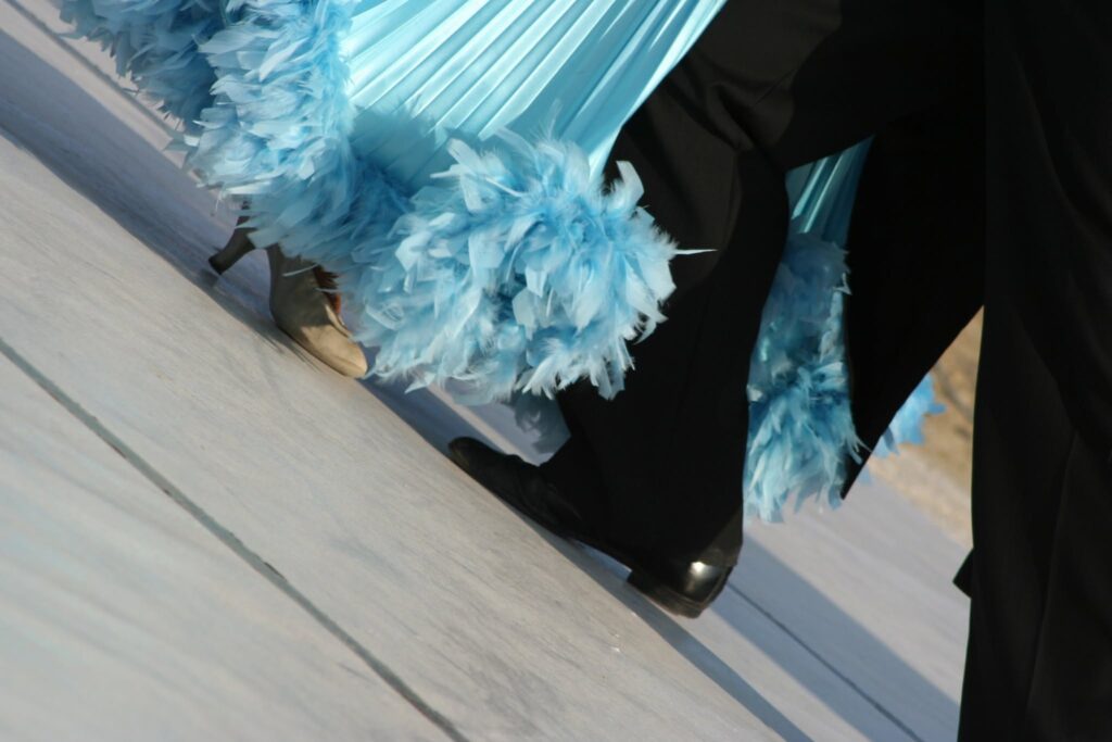 Ballroom dancers performing in feathered costumes at The Art of Ballroom dance studio in Nashville.