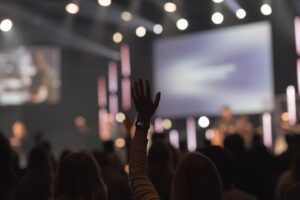Worship service at The Bridge Church in Spring Hill, Tennessee, with a congregation gathered during music and prayer.