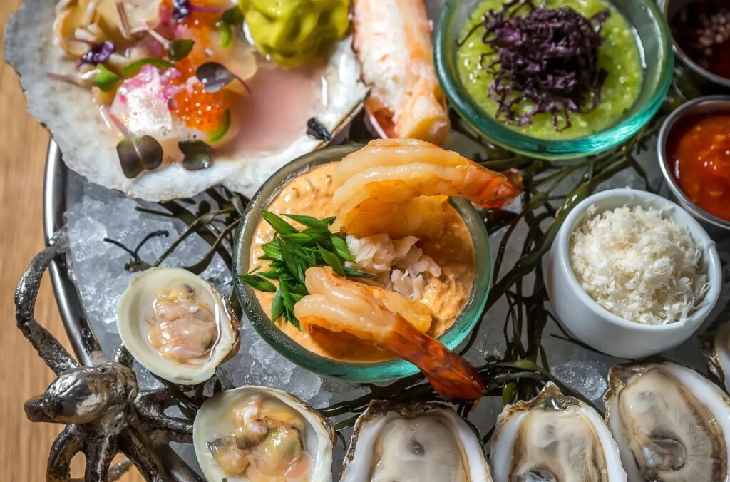 Seafood platter with oysters, shrimp, crab, sauces, and accompaniments served at The Dutch in Nashville, Tennessee.