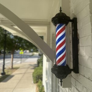 Classic barber pole outside The Haven Barber Parlour in Westhaven, Franklin, Tennessee.