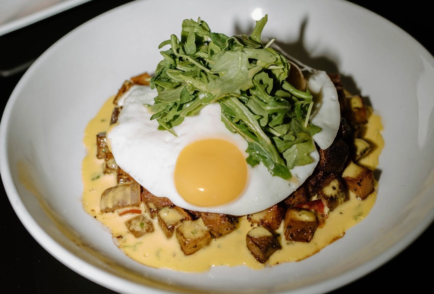 Prime rib breakfast hash with a fried egg and greens at The Rutledge in Franklin, TN.