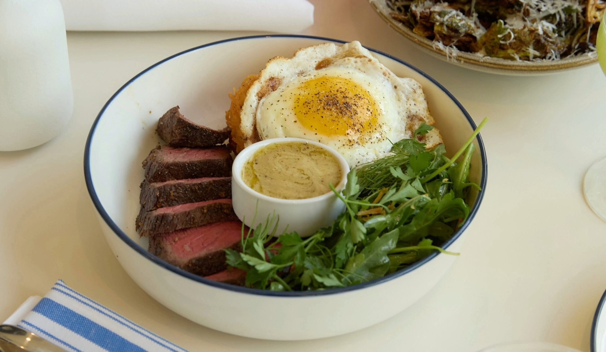 Steak and egg brunch bowl with greens at Two Hands in Franklin, TN.