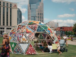 Colorful public art installation at Walk of Fame Park in downtown Nashville, Tennessee, with the city skyline in the background.