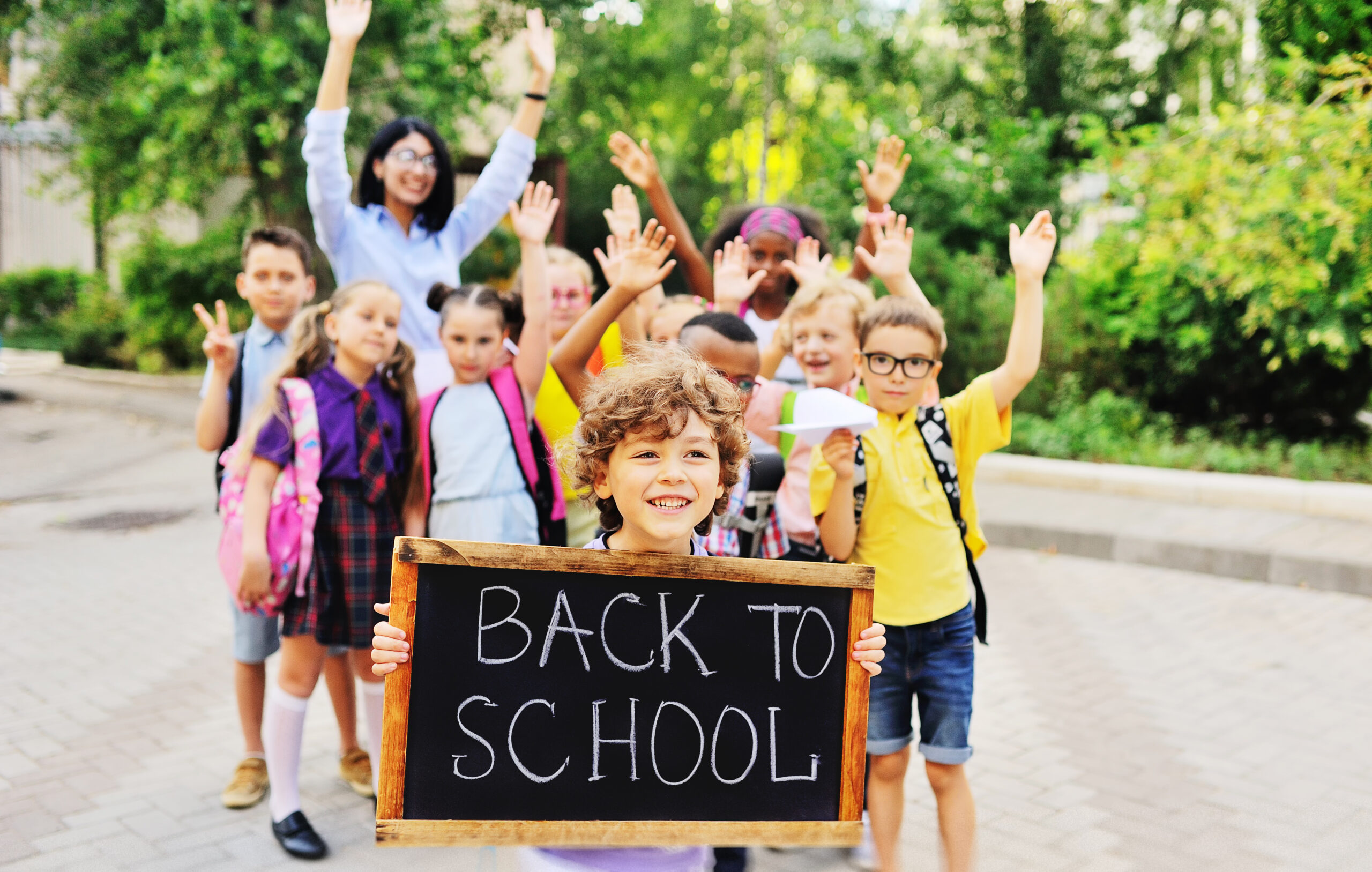 Students with backpacks holding a 
