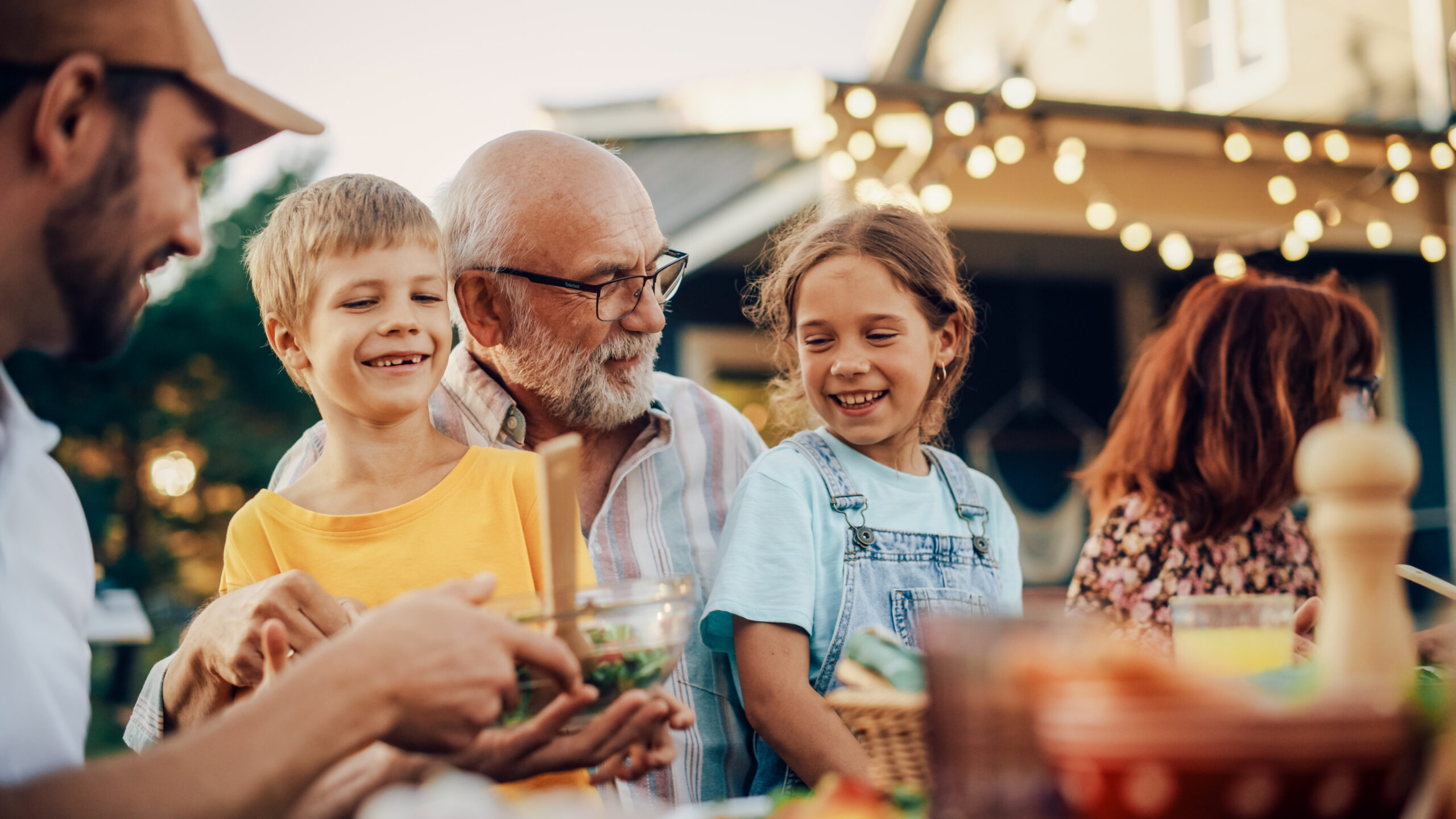 Multi-generational family enjoying an outdoor dinner together during late summer before the start of the school year in Williamson County, Tennessee.
