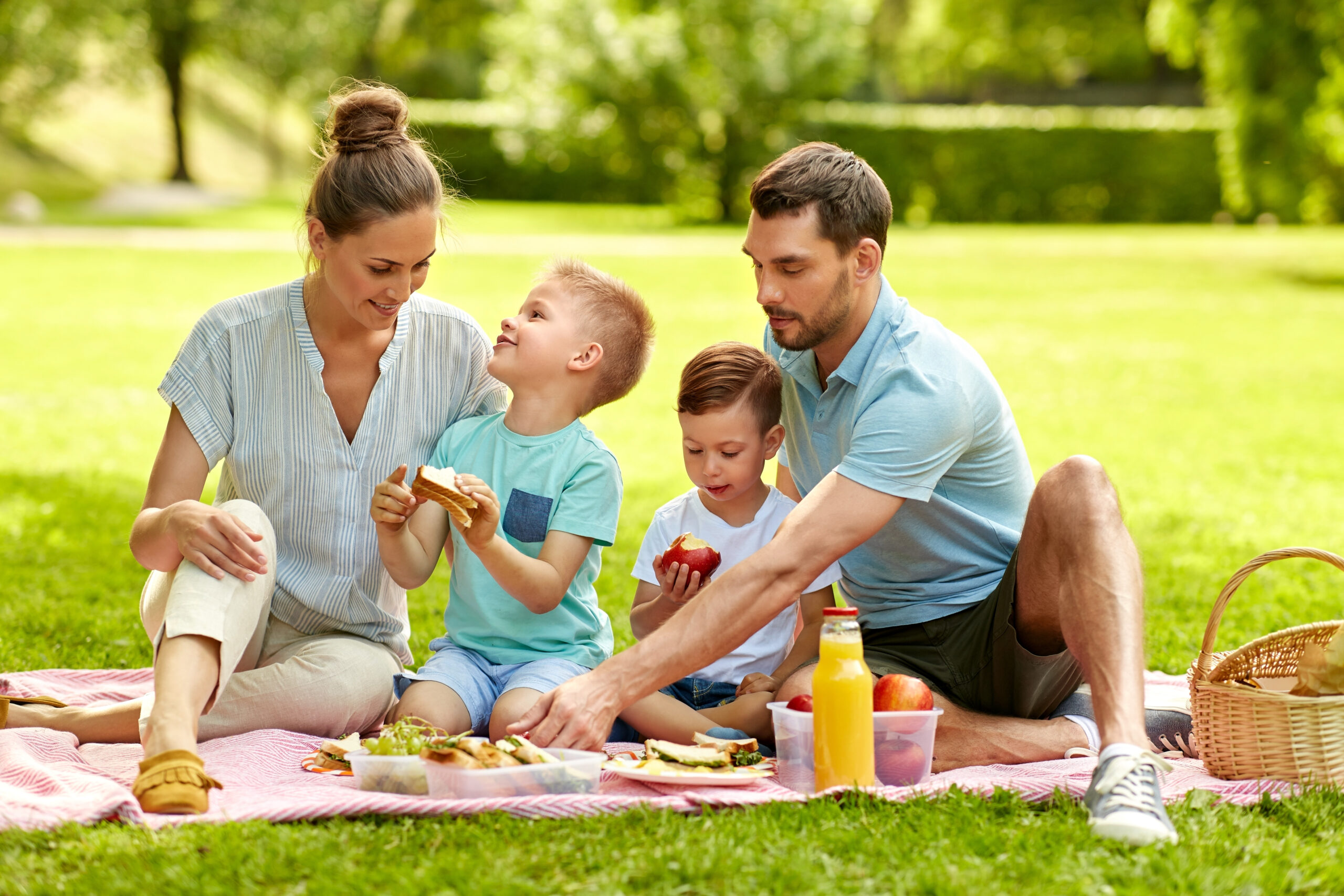 Family enjoying a picnic together at a park in Franklin, TN before the start of the school year.