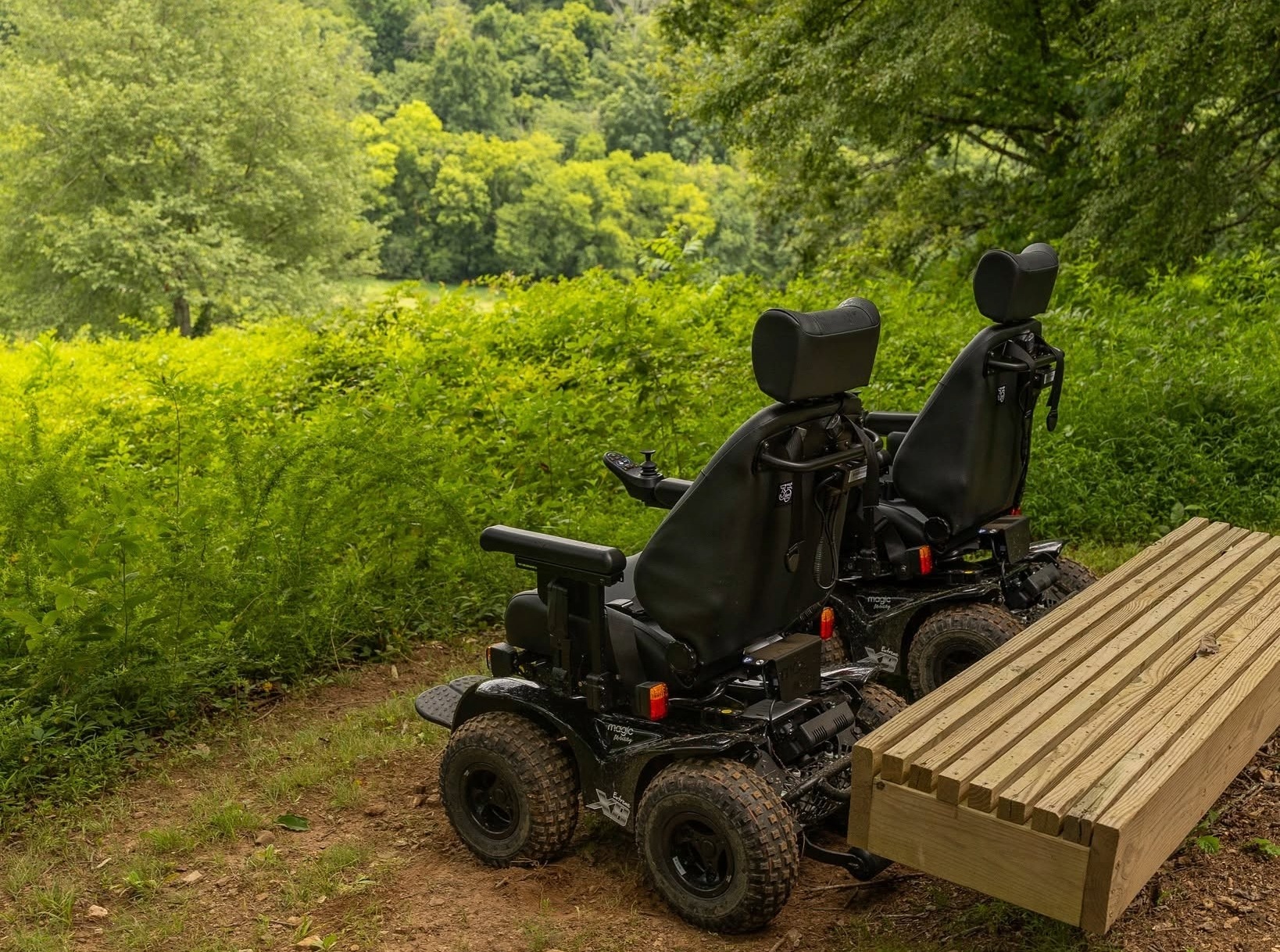 Two all-terrain wheelchairs on a trail at Peacock Hill Nature Park in College Grove, Tennessee.
