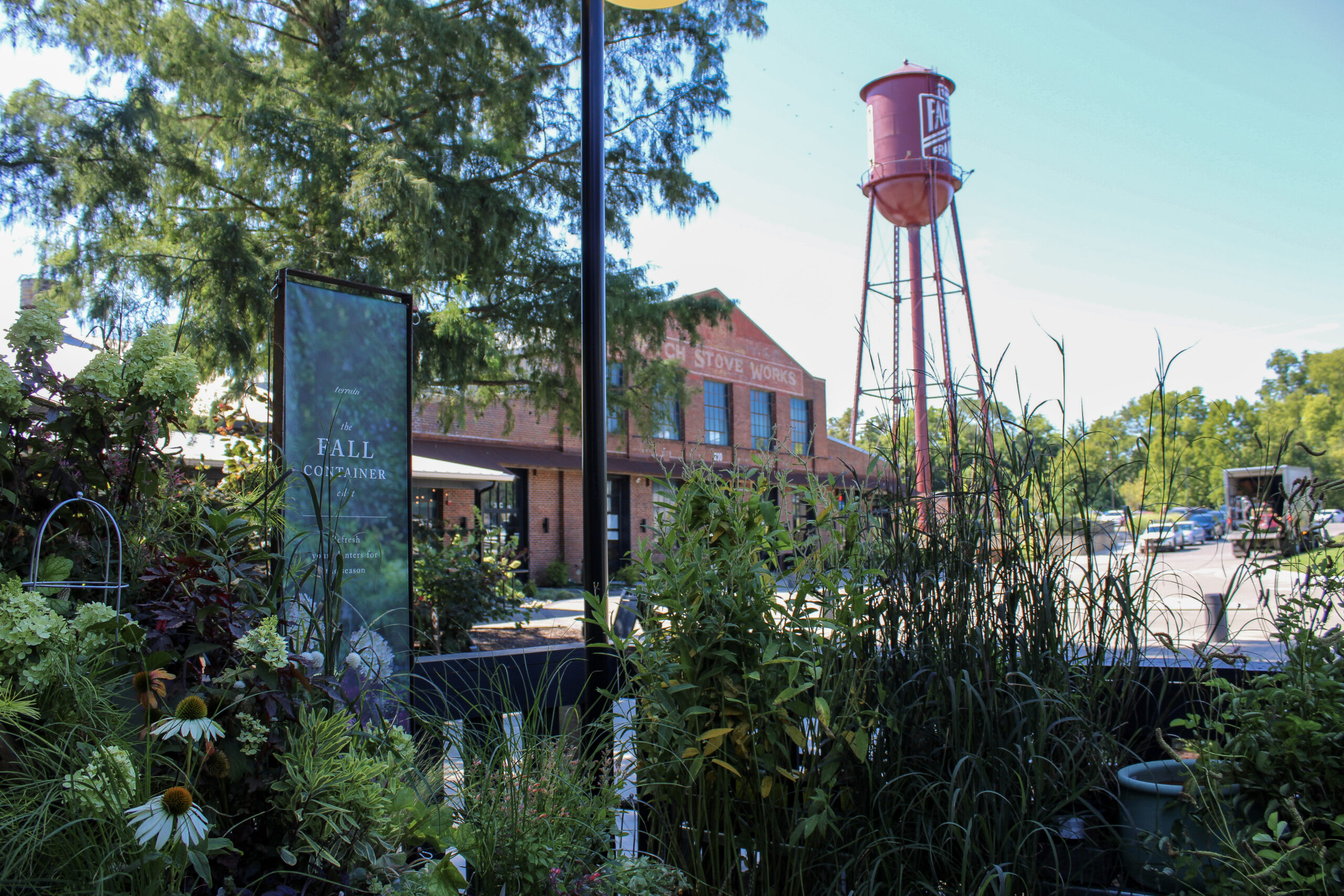 Outdoor plants at Terrain with The Factory at Franklin water tower in the background