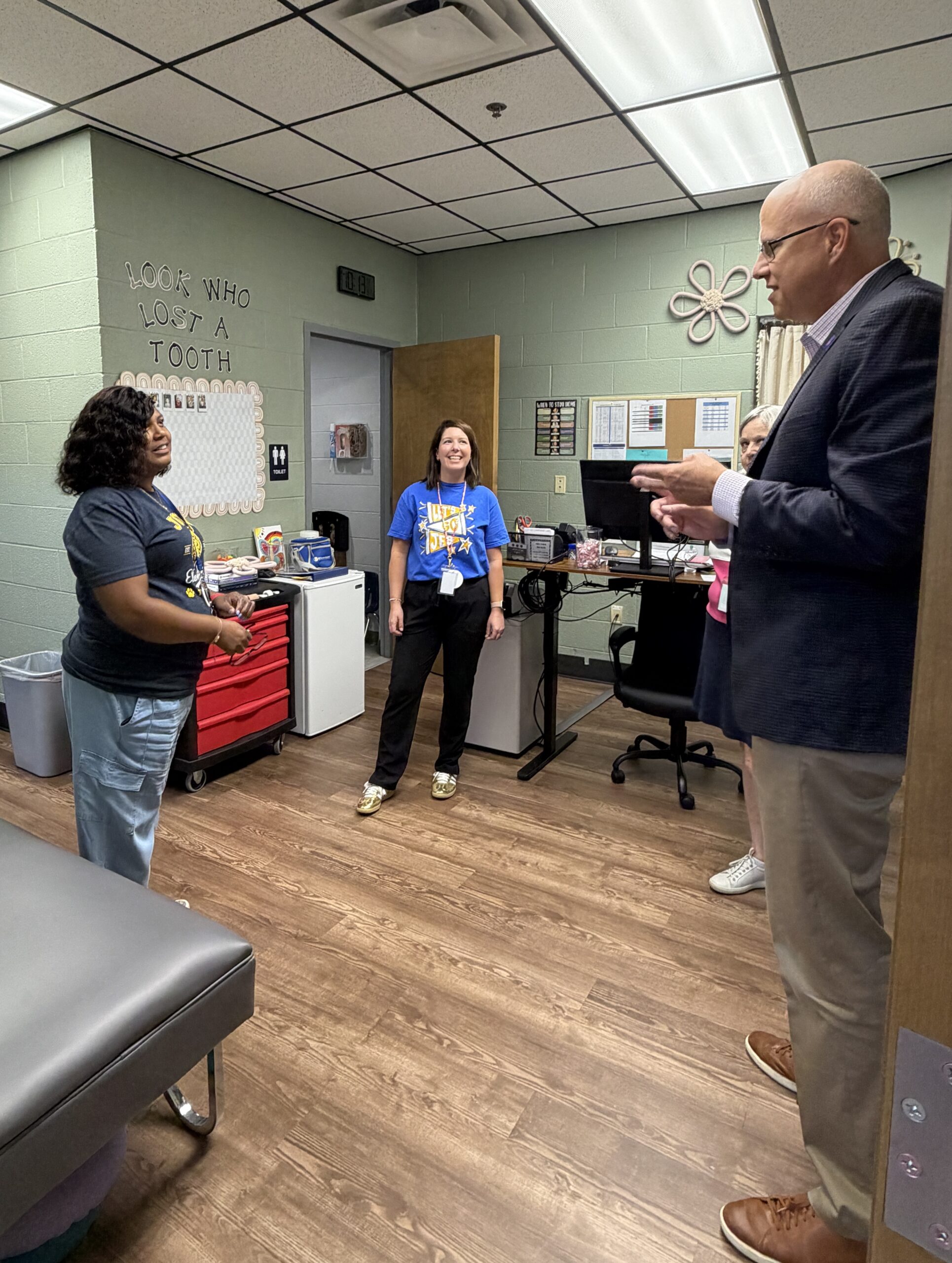 Jason Golden meets Johnson Elementary School Principal Tosha Robinson Baugh and Nurse Heidi Garzini during a tour of the school.