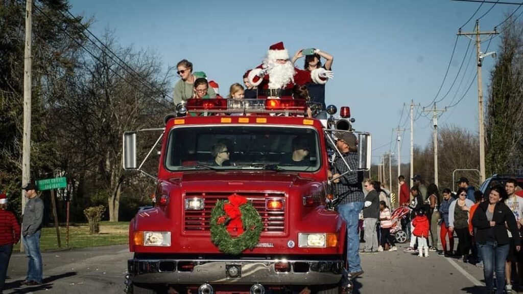College Grove Christmas Parade, Santa waving from a wreath-decorated fire truck.