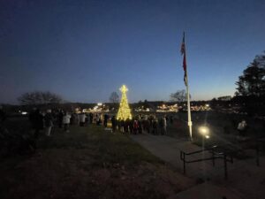 Crowd gathered around the lit Christmas tree at Fairview City Hall