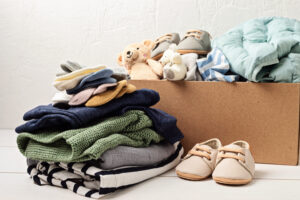 Baby and child clothes, toys in box. Second hand apparel in Franklin, TN