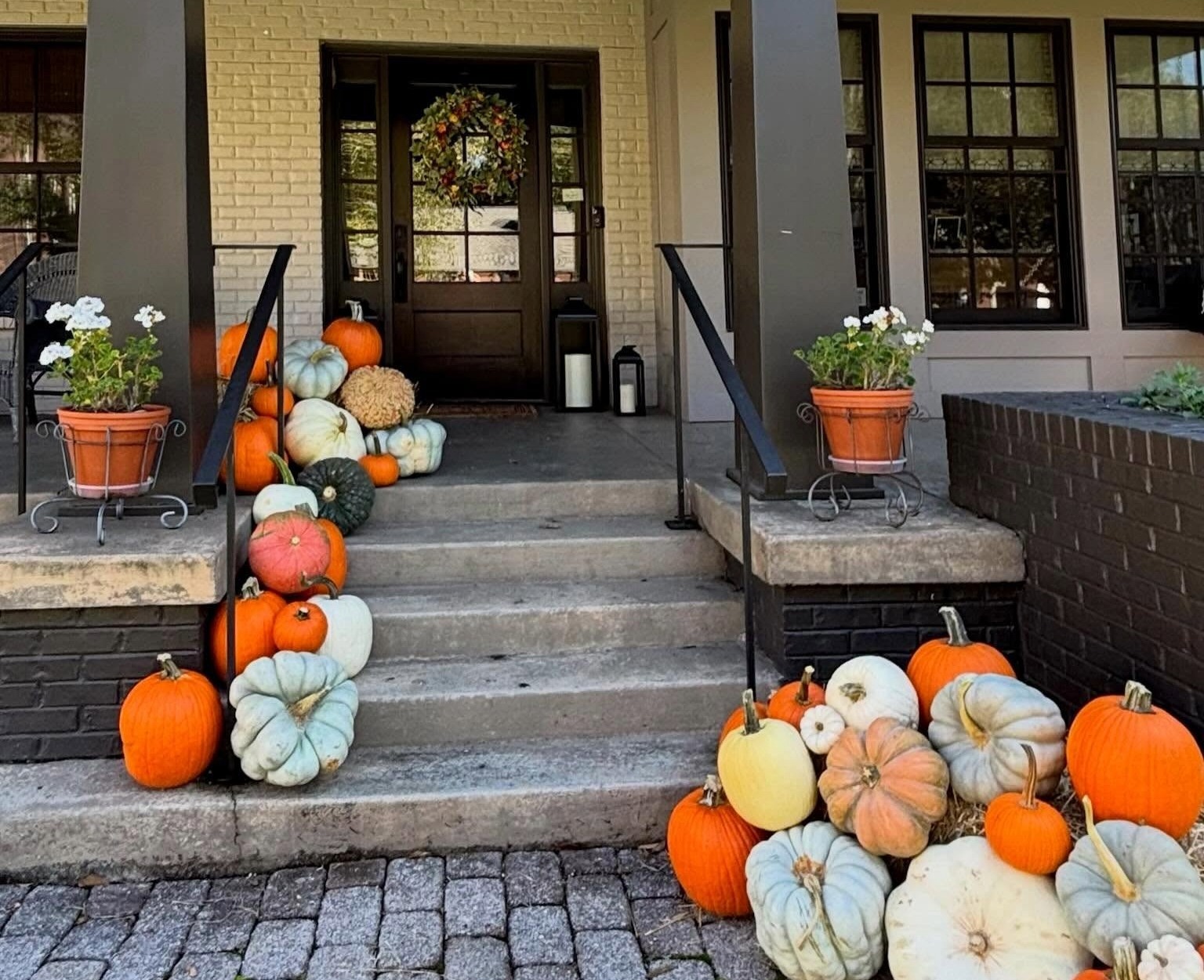 Fall porch decorated with orange, white, green, and heirloom pumpkins by The Porch Patch in Franklin, TN