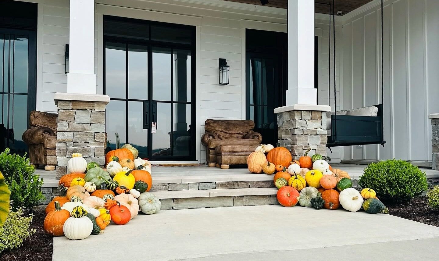 Fall porch decorated with pumpkins and gourds by The Pumpkin Dispatch in Franklin, TN