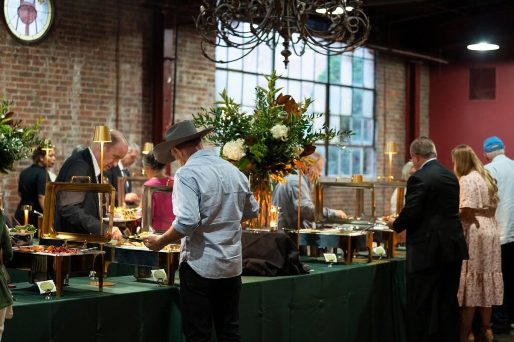 Guests serving themselves from a catered buffet by Catering & Events by Suzette in Franklin, Tennessee.