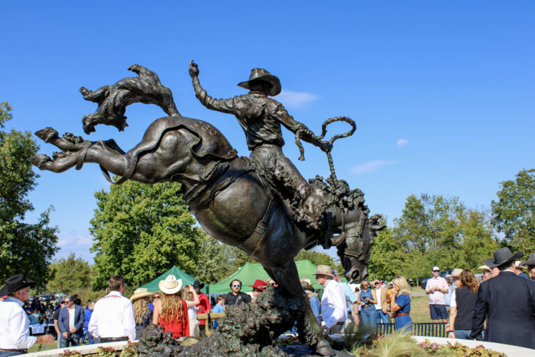 Bronze sculpture of a cowboy riding a bucking horse by artist Scott Rogers at the Franklin Rodeo Plaza unveiling in Jim Warren Park, Franklin, Tennessee.