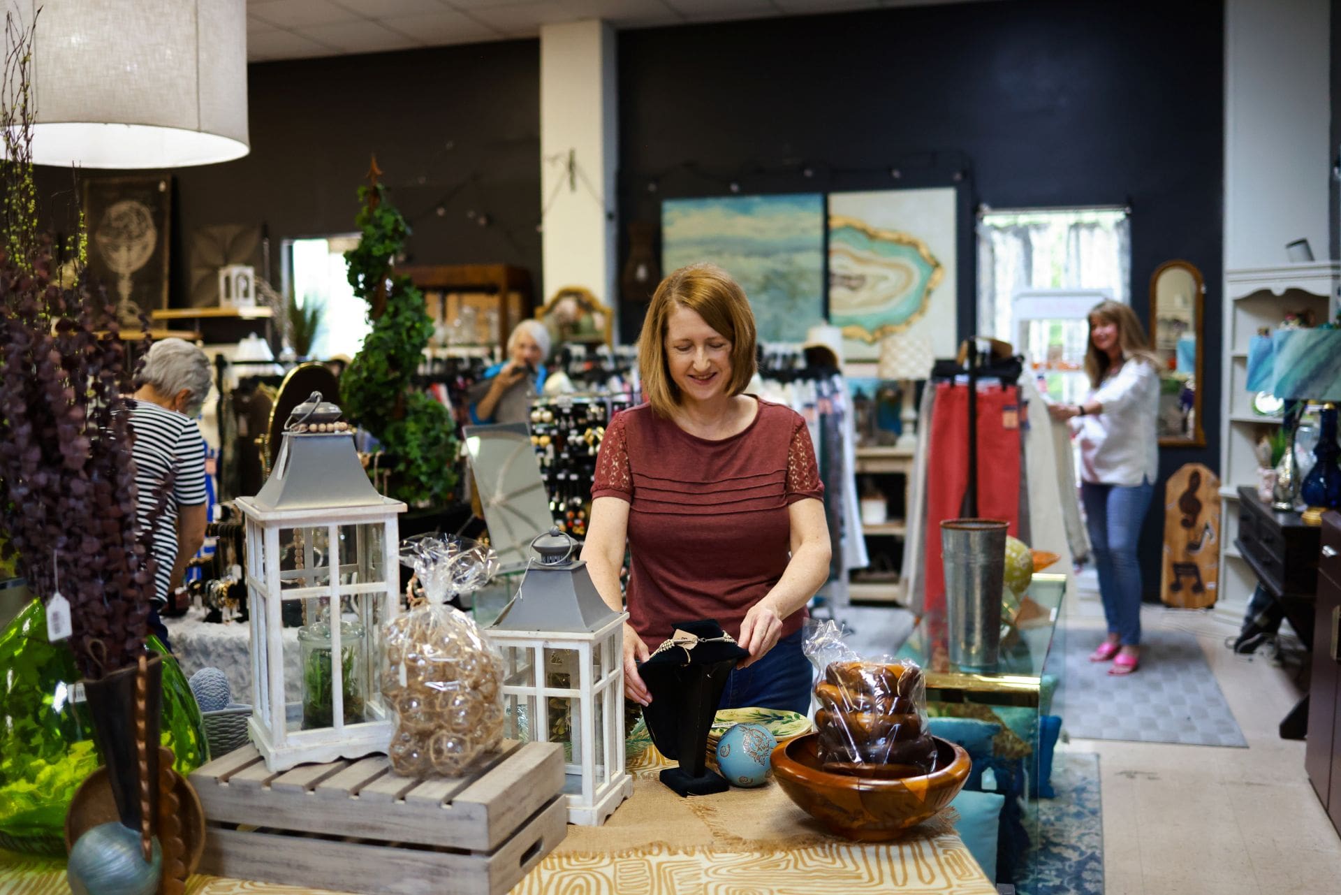 Shopper browsing home decor and accessories inside GraceWorks Thrift in Franklin, Tennessee.
