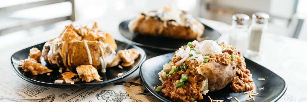 Loaded baked potatoes topped with chili, cheese, onions, jalapeños, and other toppings at Ground in Franklin, Tennessee.