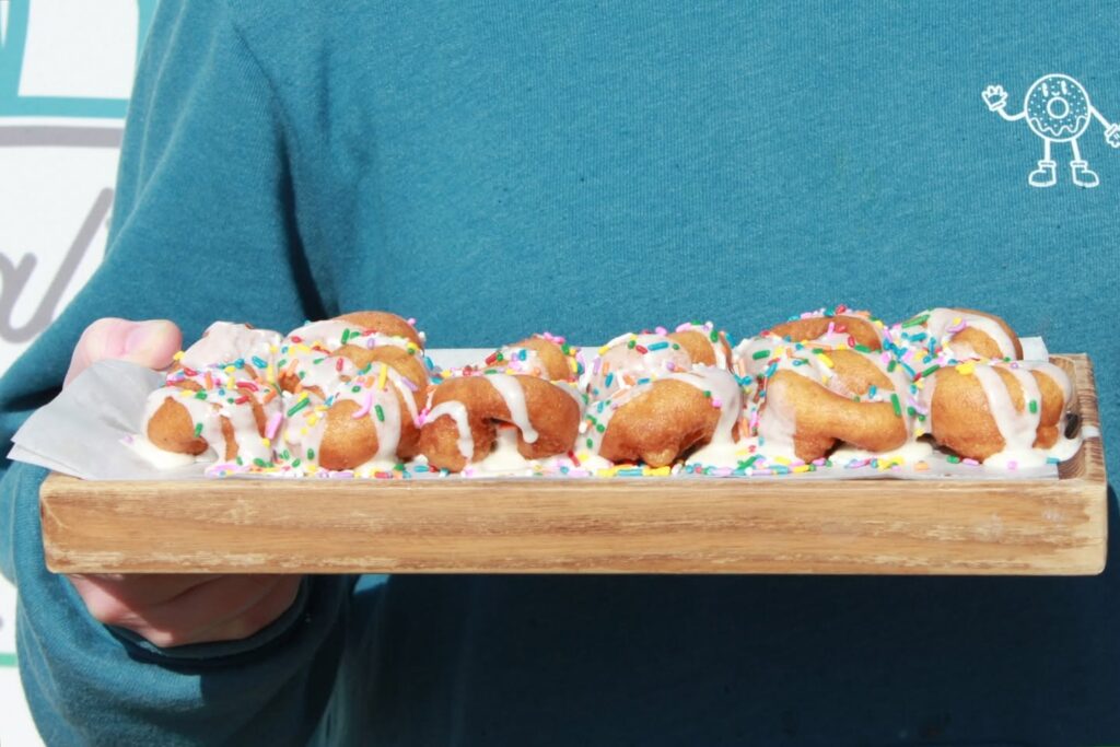 Fresh mini donuts topped with icing and colorful sprinkles from Itty Bitty Donuts in Nolensville, Tennessee.
