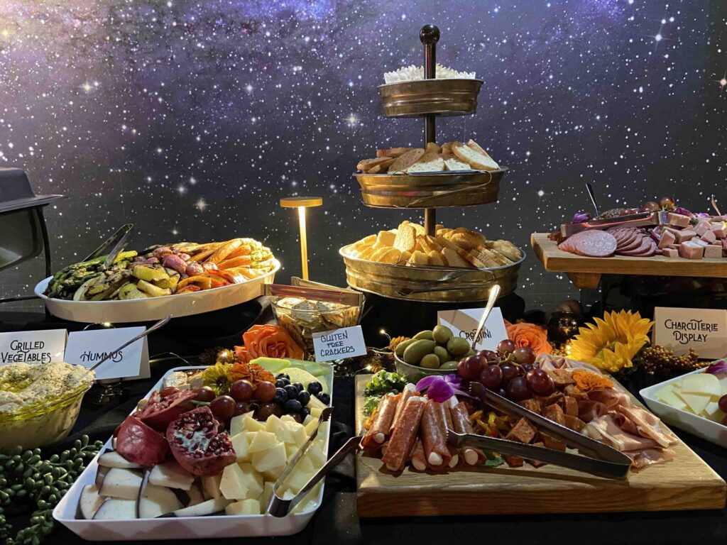 Catering spread with charcuterie, breads, vegetables, fruit, cheeses, and appetizers from Menu Maker Catering & Events in Franklin, Tennessee.