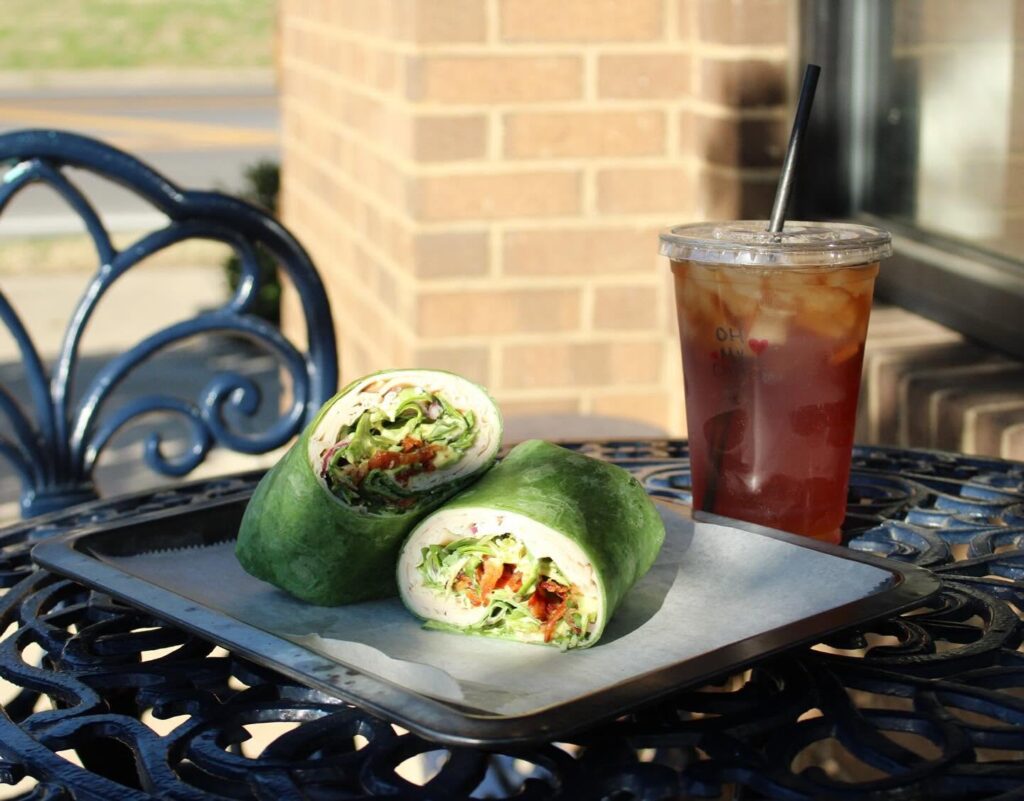 Wrap sandwich and iced tea served on an outdoor table at Oh My Chives in Nolensville, Tennessee.