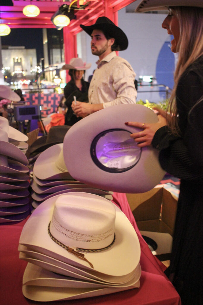 Cowboy and cowgirl customizing hats on the outdoor patio at Puesto Mexican restaurant in Nashville Yards, Nashville, TN.