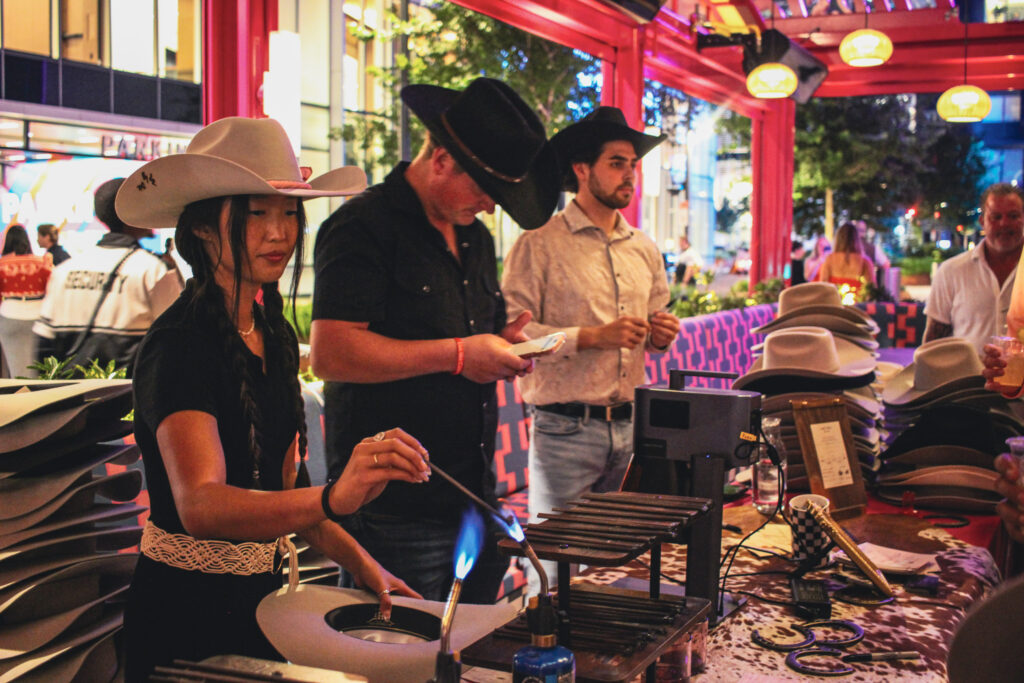 Cowboy hat branding station on the outdoor patio at Puesto Mexican restaurant in Nashville Yards, Nashville, TN.