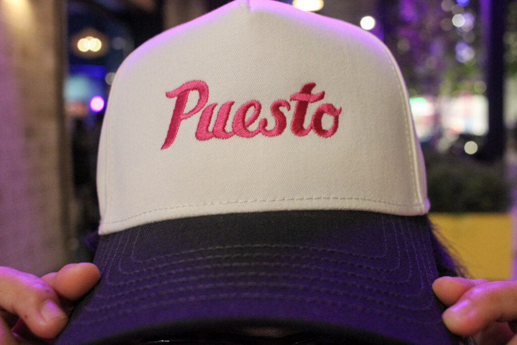Puesto hat featuring the restaurant logo at Nashville Yards in Nashville, TN.