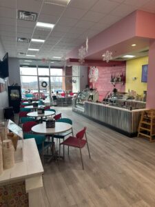 Interior of Sweet CeCe’s in Nolensville, Tennessee, with colorful seating and the frozen dessert counter.