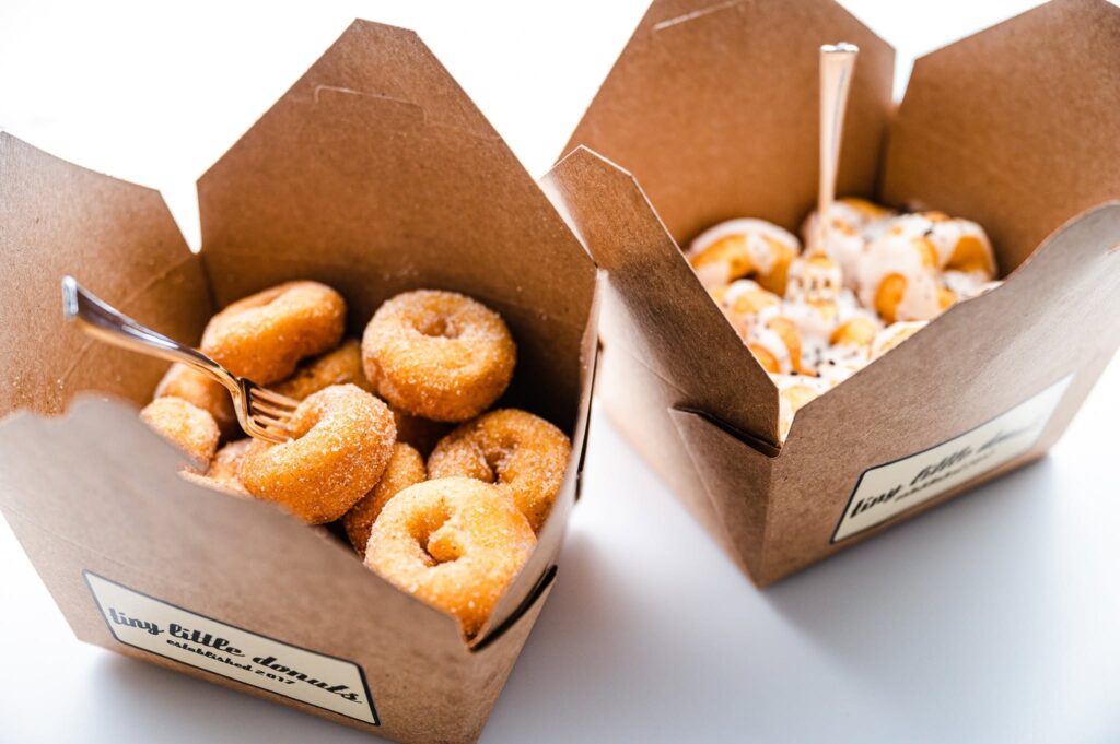 Boxes of freshly made mini donuts with cinnamon sugar and glazed toppings from Tiny Little Donuts in Franklin, Tennessee.