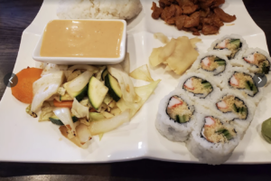 Sushi rolls served with rice, vegetables, ginger, sauce, and a cooked Asian entrée at Yuno Sushi & Asian Cuisine in Nolensville, Tennessee.